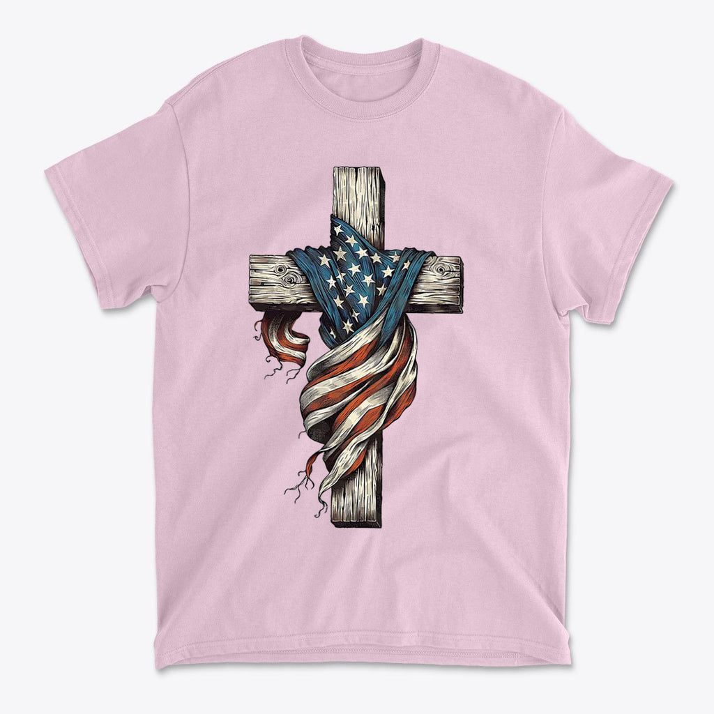 American Flag On The Cross Style design on a pink t-shirt featuring a wooden cross and flowing US flag.
