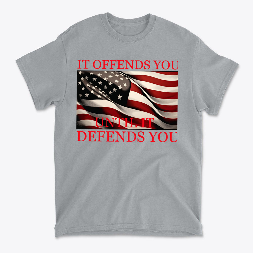 If Offends You Until It Defends You graphic t-shirt featuring American flag design and bold text on gray background.