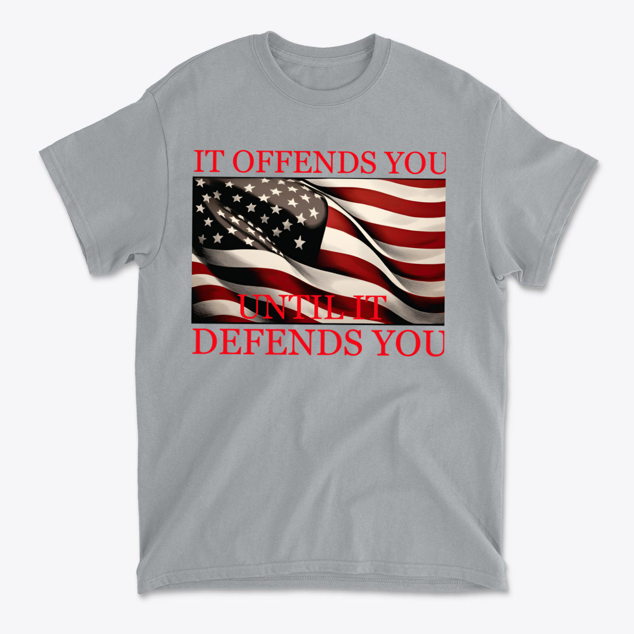 If Offends You Until It Defends You graphic t-shirt featuring American flag design and bold text on gray background.