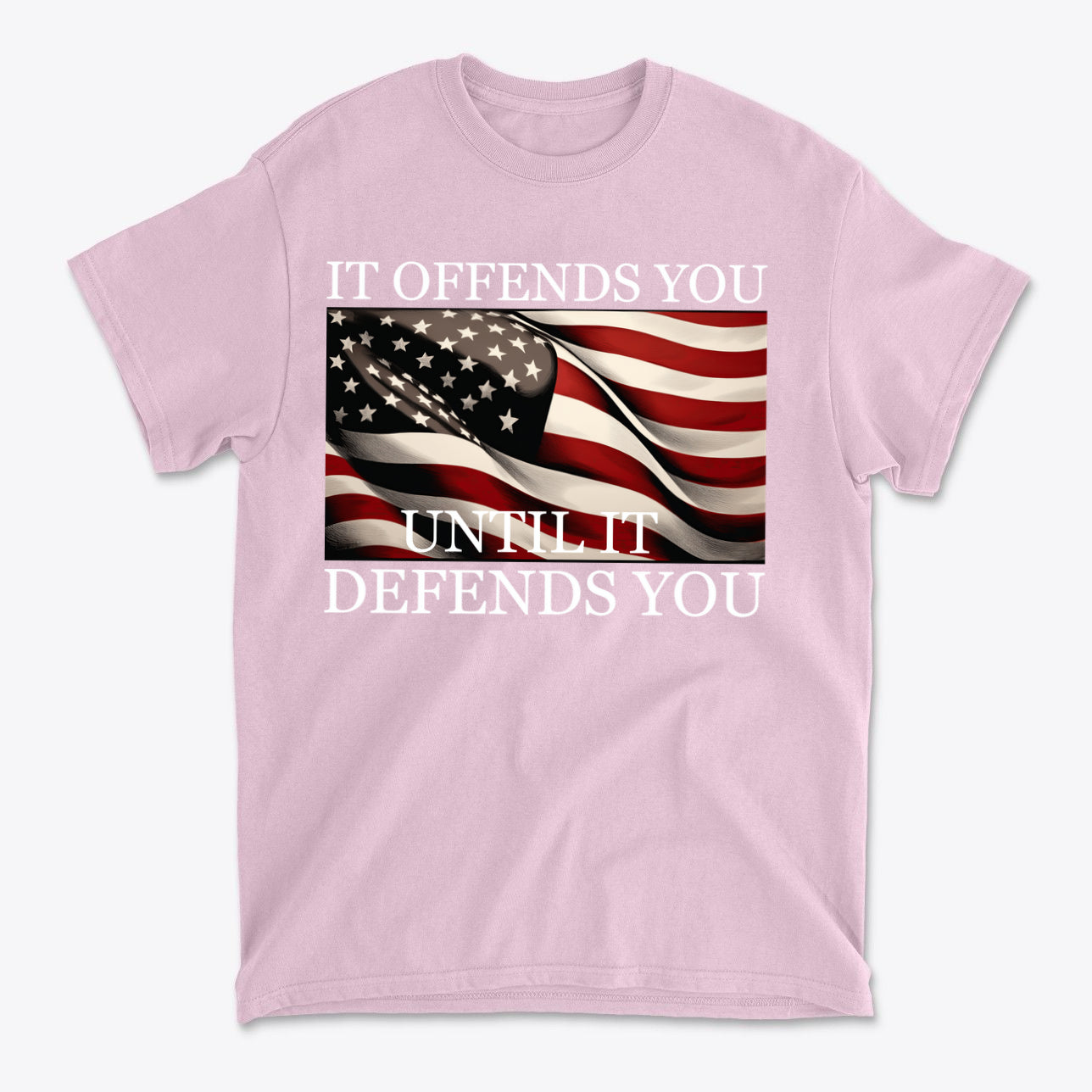 It Offends You Until It Defends You Wht Ltrs pink t-shirt featuring American flag design.