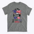 Graphic tee with the phrase 'She Loves Jesus And America Too' and a hair design featuring patriotic colors.