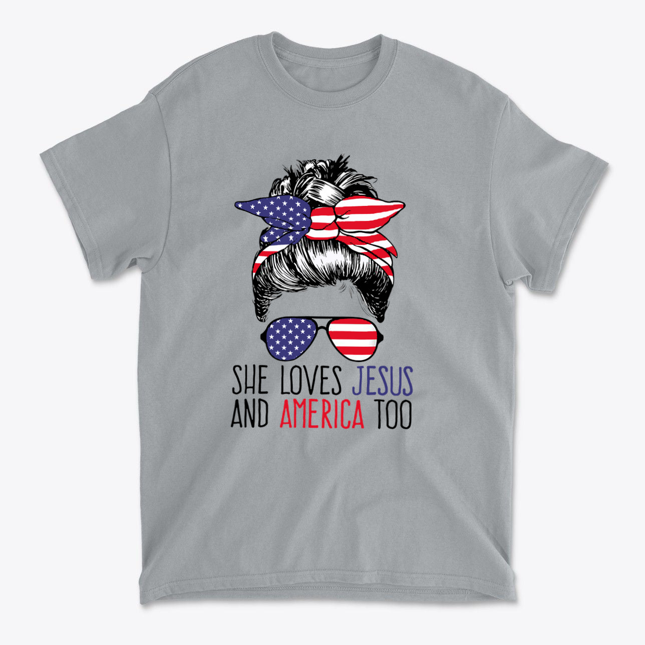 Gray t-shirt featuring a design with a hairstyle, sunglasses, and the text 'She Loves Jesus And America Too'.