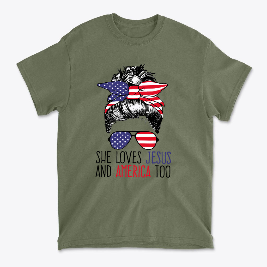 She Loves Jesus And America Too graphic t-shirt with patriotic design on olive green background.