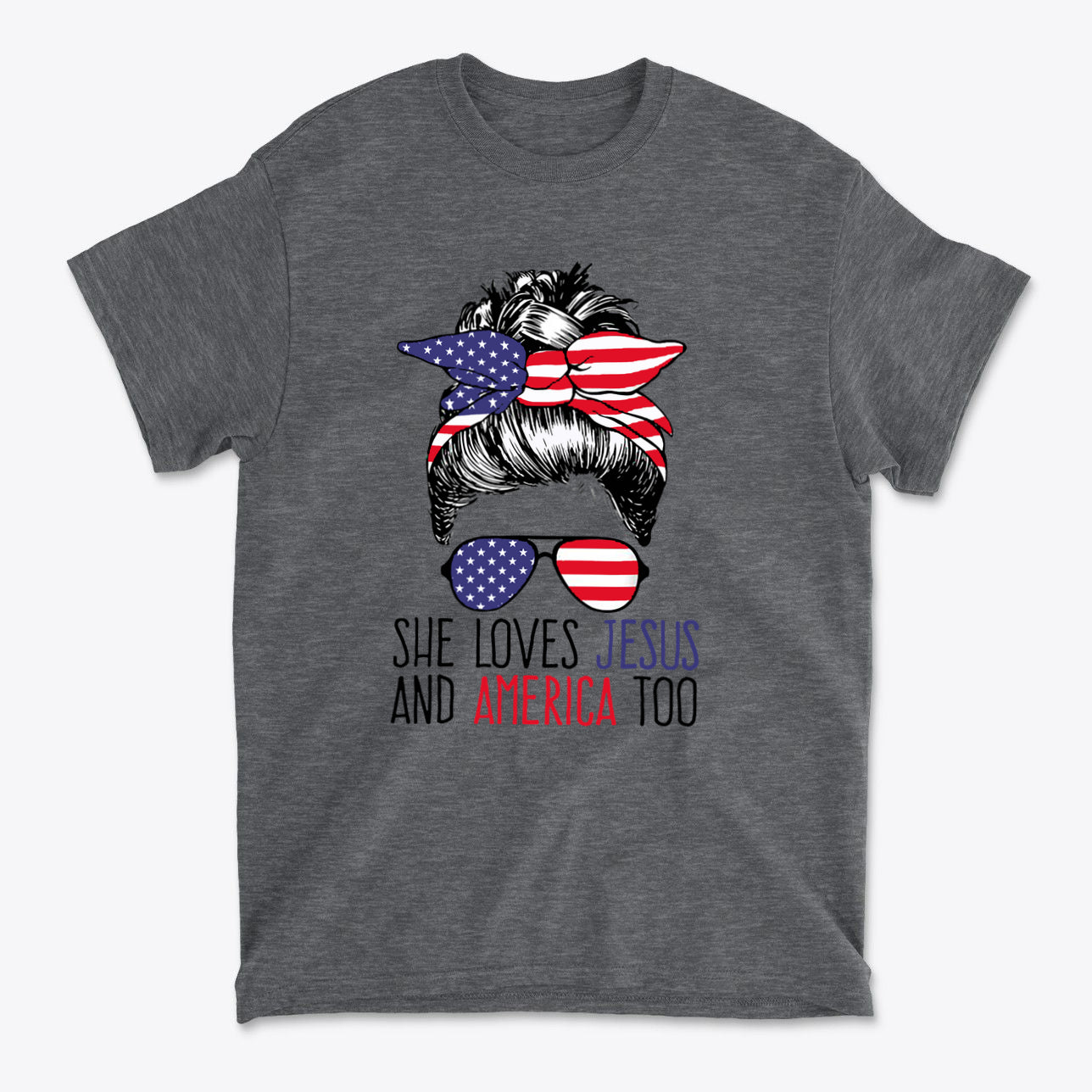 Graphic tee featuring a hairstyle with American flag bandana and sunglasses, text reads 'She Loves Jesus And America Too'.