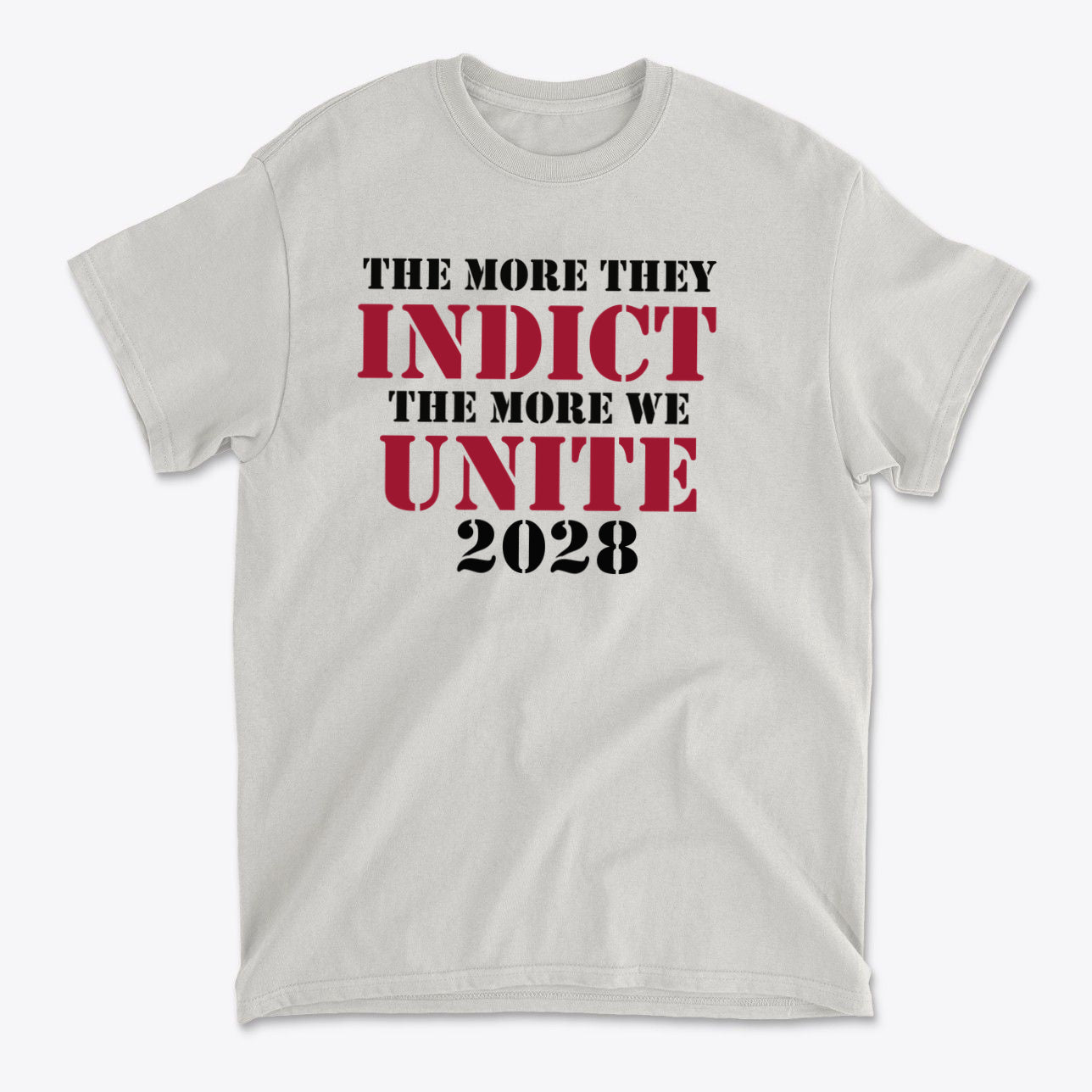 The More They Indict The More We Unite 2028 Blk Ltrs graphic t-shirt featuring bold text design.