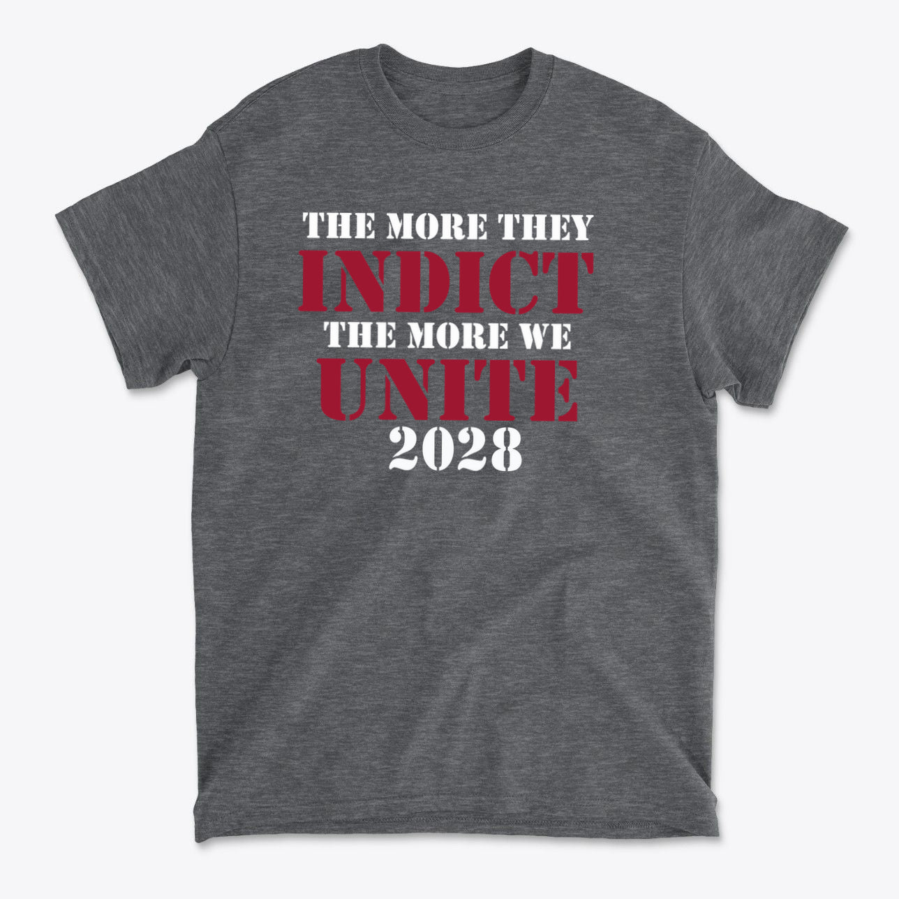 The More They Indict The More We Unite 2028 Wht Ltrs graphic tee showcasing a powerful political message.