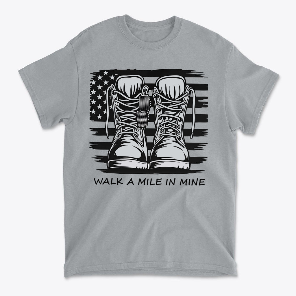 Walk A Mile In Mine Apparel Art featuring military boots on a grey t-shirt with an American flag design.
