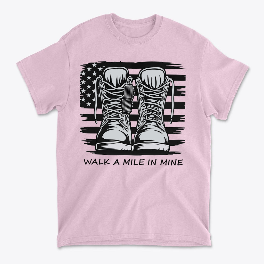 Walk A Mile In Mine Apparel Art featuring combat boots design on a pink t-shirt with an American flag background.