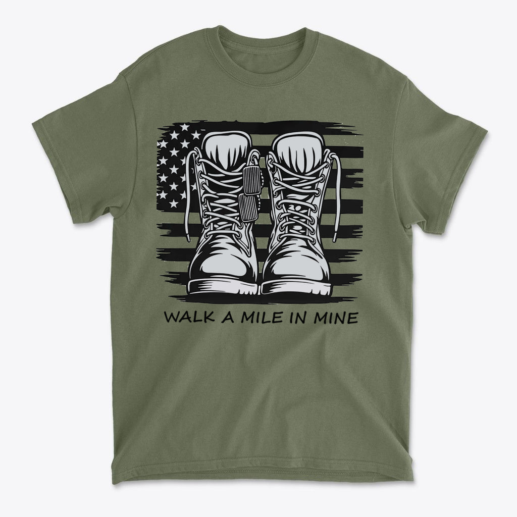 Walk A Mile In Mine Apparel Art featuring combat boots on an olive green shirt with a flag background.