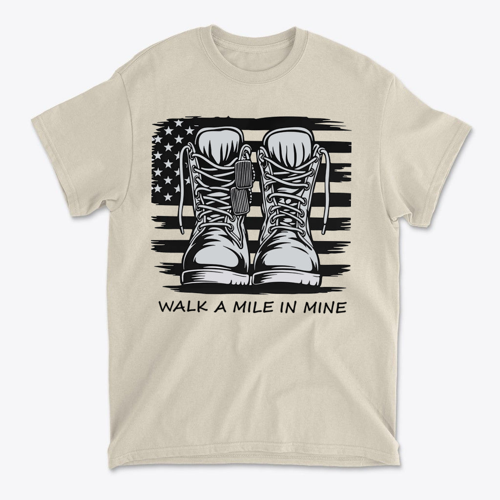 Walk A Mile In Mine Apparel Art featuring boots and an American flag design on a beige shirt.