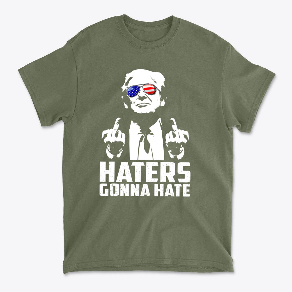 Haters Gonna Hate Graphic Design on an olive green t-shirt featuring a graphic of a confident figure with American flag sunglasses.
