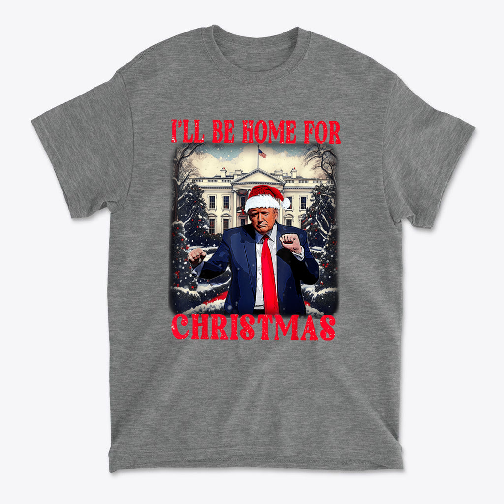 Trump Dancing Be Home For Christmas Graphic Tee featuring President Trump in a Santa hat against the White House.