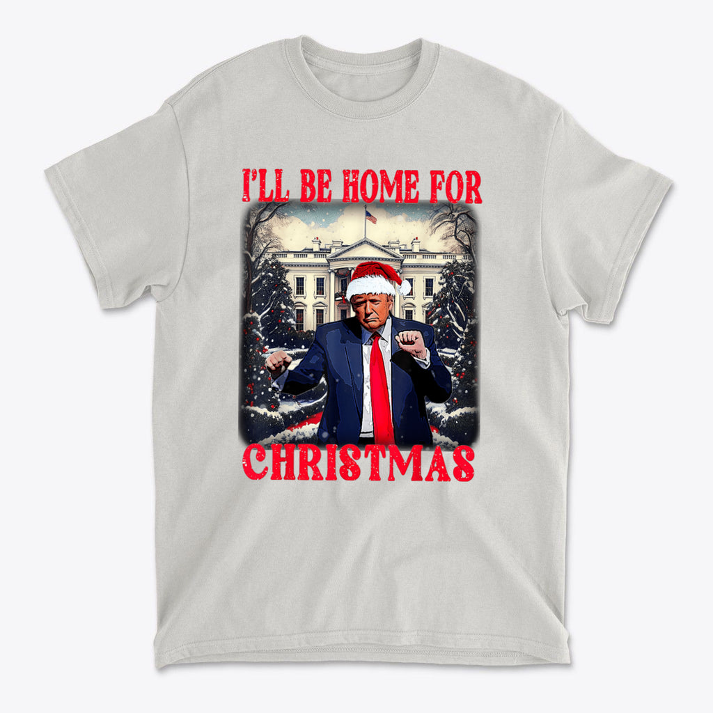 Trump Dancing Be Home For Christmas Graphic Tee featuring a dancing Trump in a Santa hat.