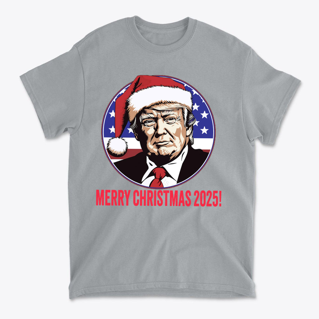 Merry Christmas 2025 Trump As Santa graphic t-shirt featuring Donald Trump in a Santa hat with patriotic colors.