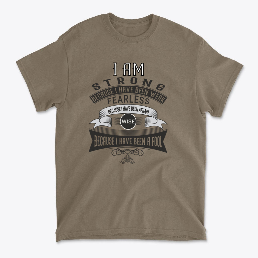 Strength After Being Weak Design graphic t-shirt featuring motivational text on a brown shirt.