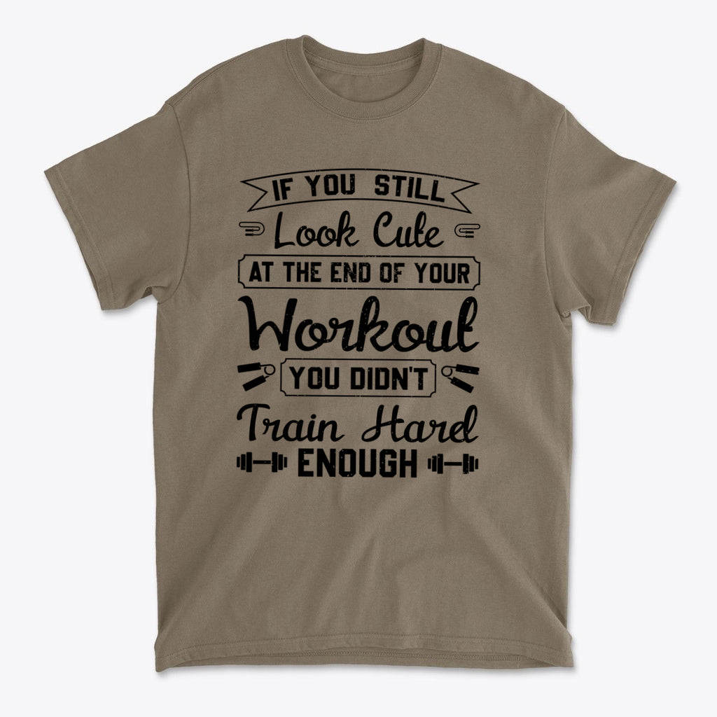 Train Hard Not Looking Cute Now t-shirt showcasing motivational workout quote in black on a tan background.