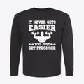 It Never Gets Easier Get Strong graphic tee showcasing a muscular design and motivational text.