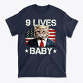 Nine Lives Baby Flag Art Style graphic tee featuring a cat in a suit against an American flag background.