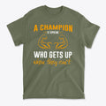 Champion Is Someone Who Gets Up Again Motivational Shirt in olive green with inspiring text design.
