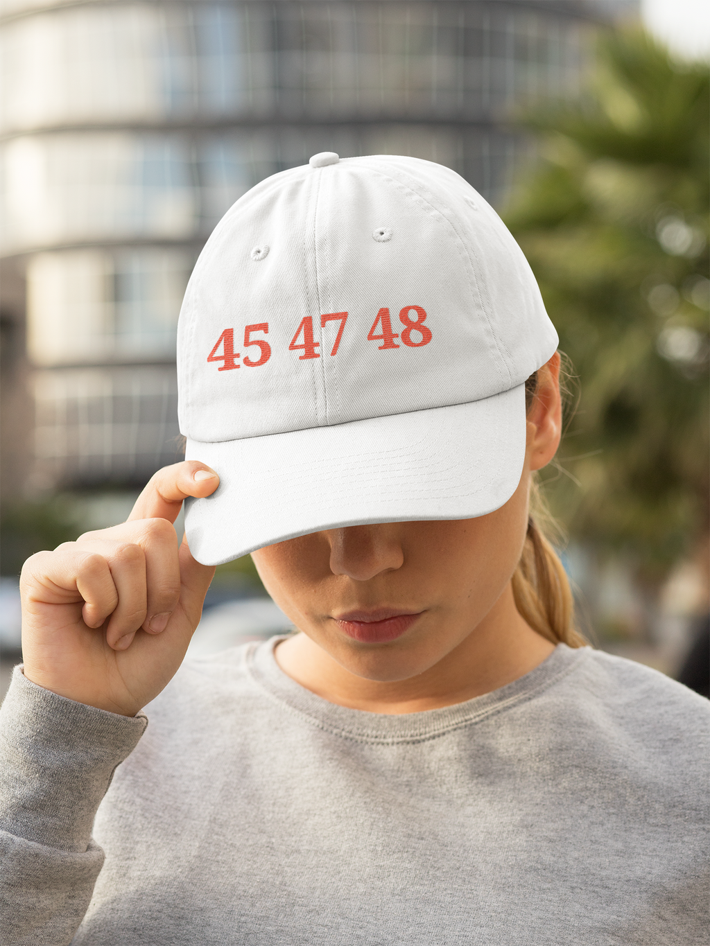 45 47 48 Trump Cap Red Word Art worn by a woman, showcasing personal values and patriotism.
