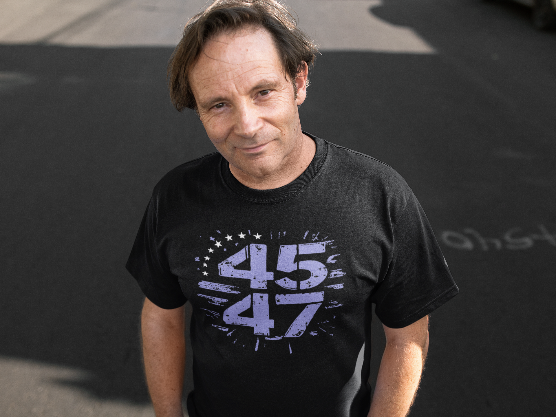 Man wearing The 45 47 Stars Graphic Design black t-shirt, showcasing a bold patriotic message.