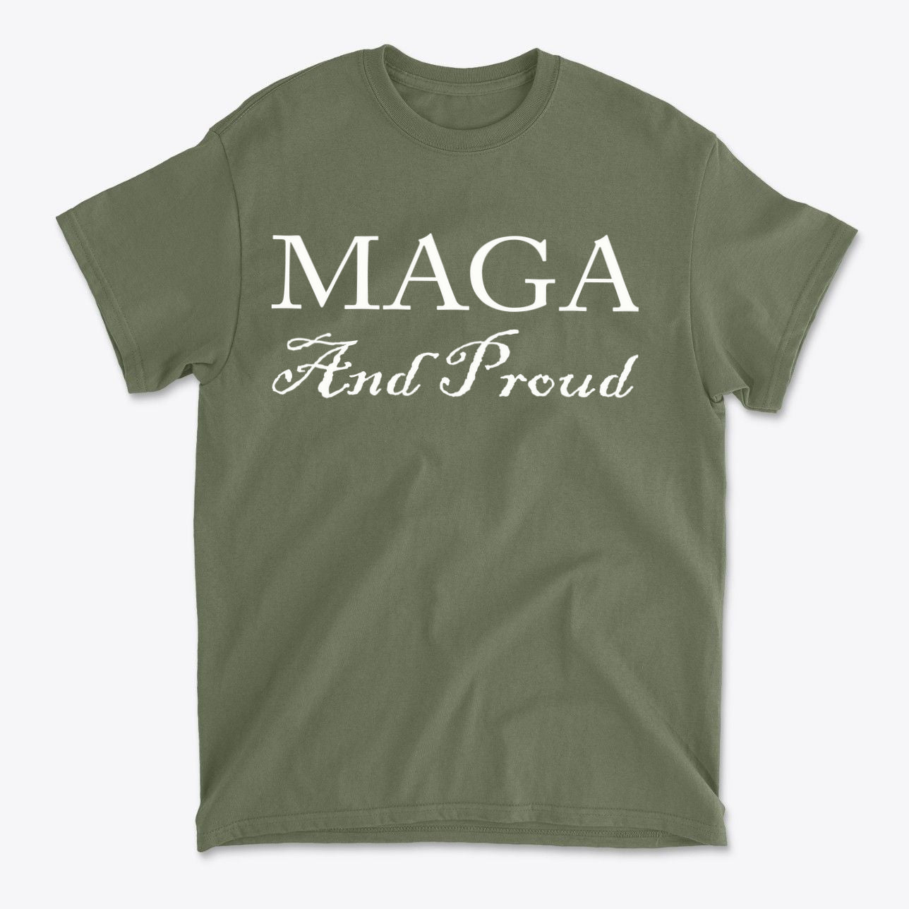 MAGA And Proud White Letters Style graphic tee displayed in olive green fabric background.