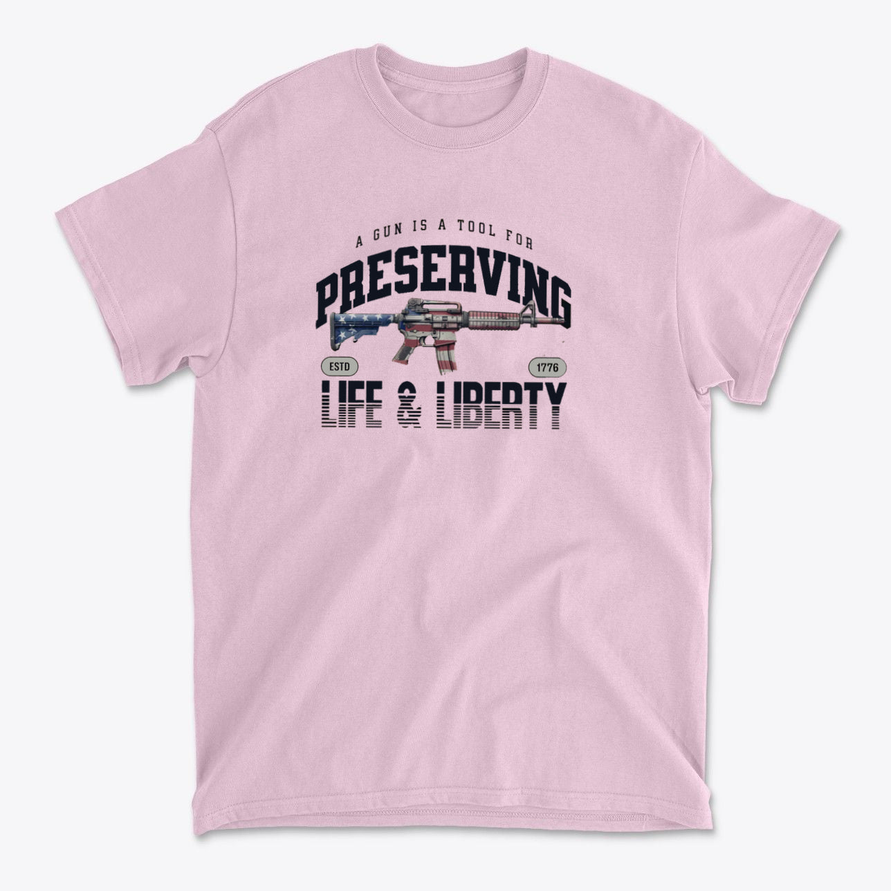 Graphic tee featuring the phrase A Gun Is A Tool For Preserving Life and Liberty on a pink background.
