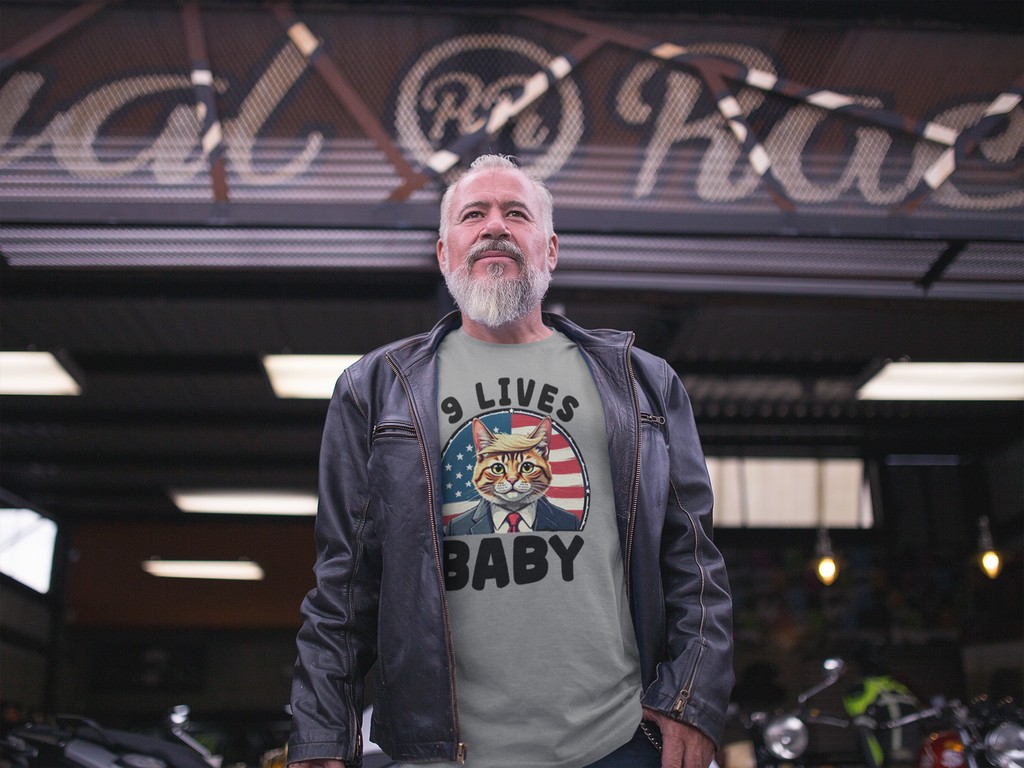 Man wearing Nine Lives US Flag Round Design graphic tee in front of a vintage shop.