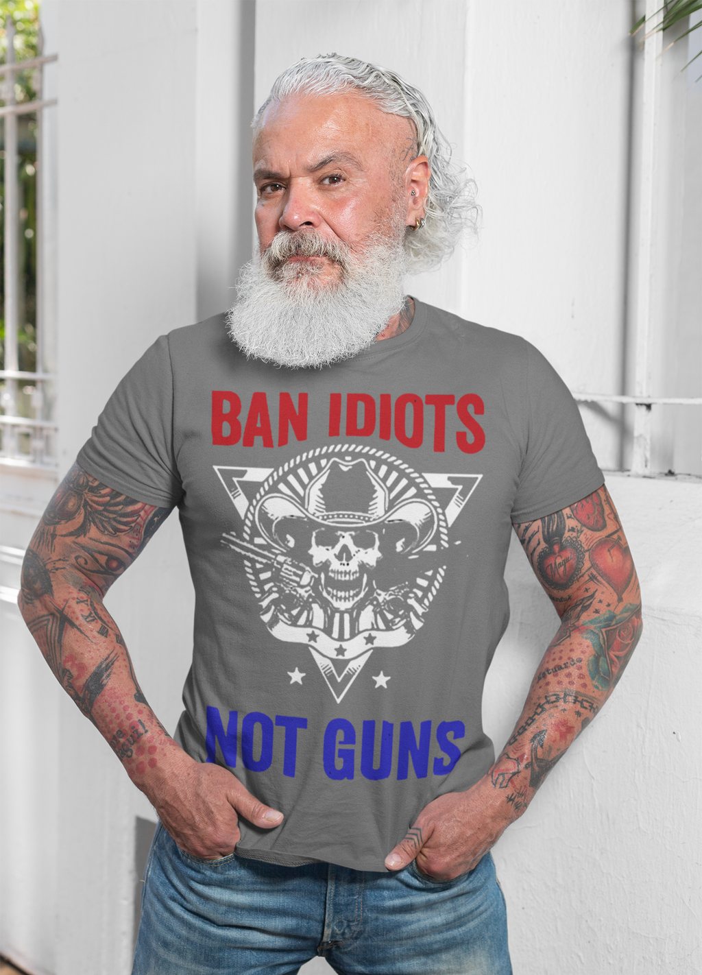 Man wearing a gray t-shirt with the text 'BAN IDIOTS NOT GUNS' showcasing the Ban Idiots Not Guns Custom Print design.