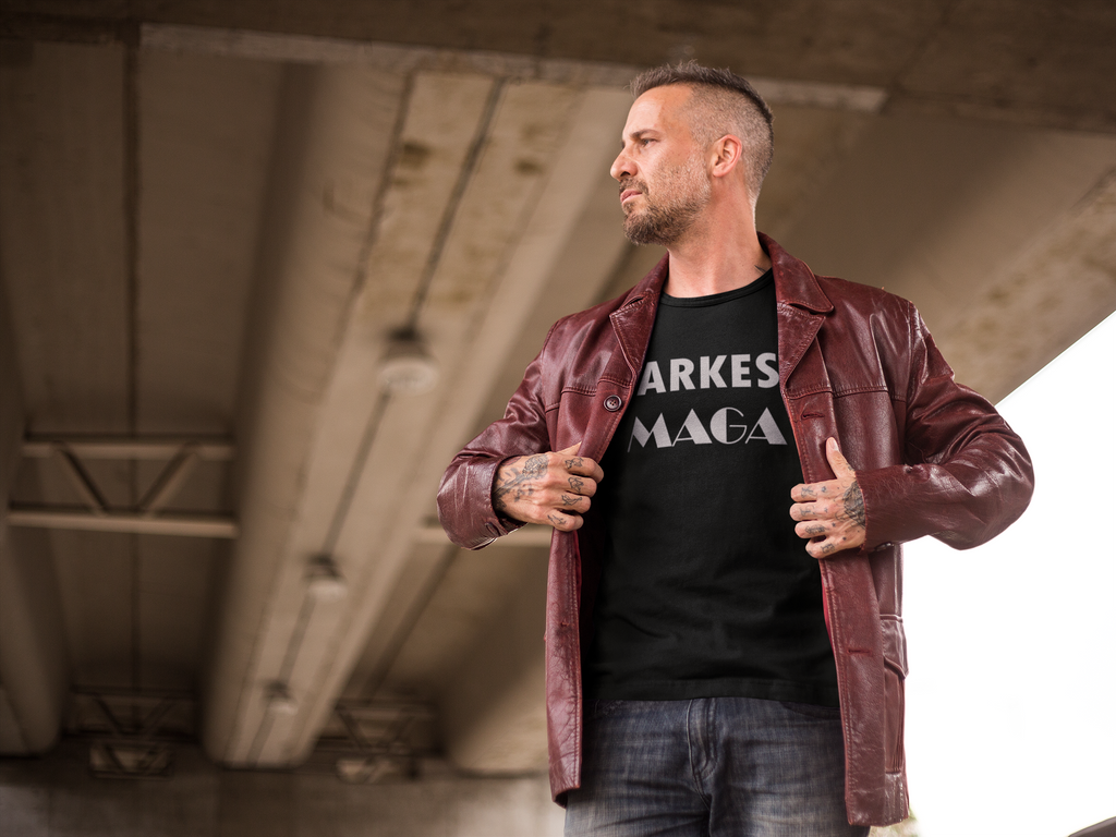 Man wearing Darkest MAGA Graphic Design Tee under a bridge showcasing his patriotism.