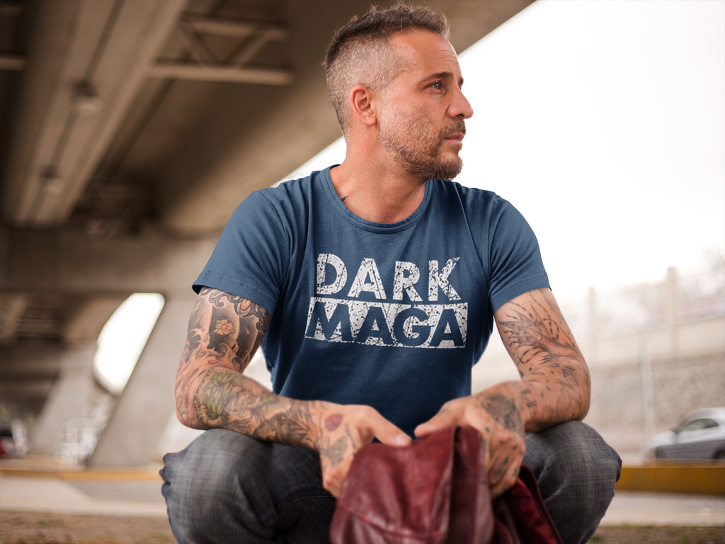 Man wearing Dark MAGA Aesthetic Design Gear t-shirt sitting under a bridge.