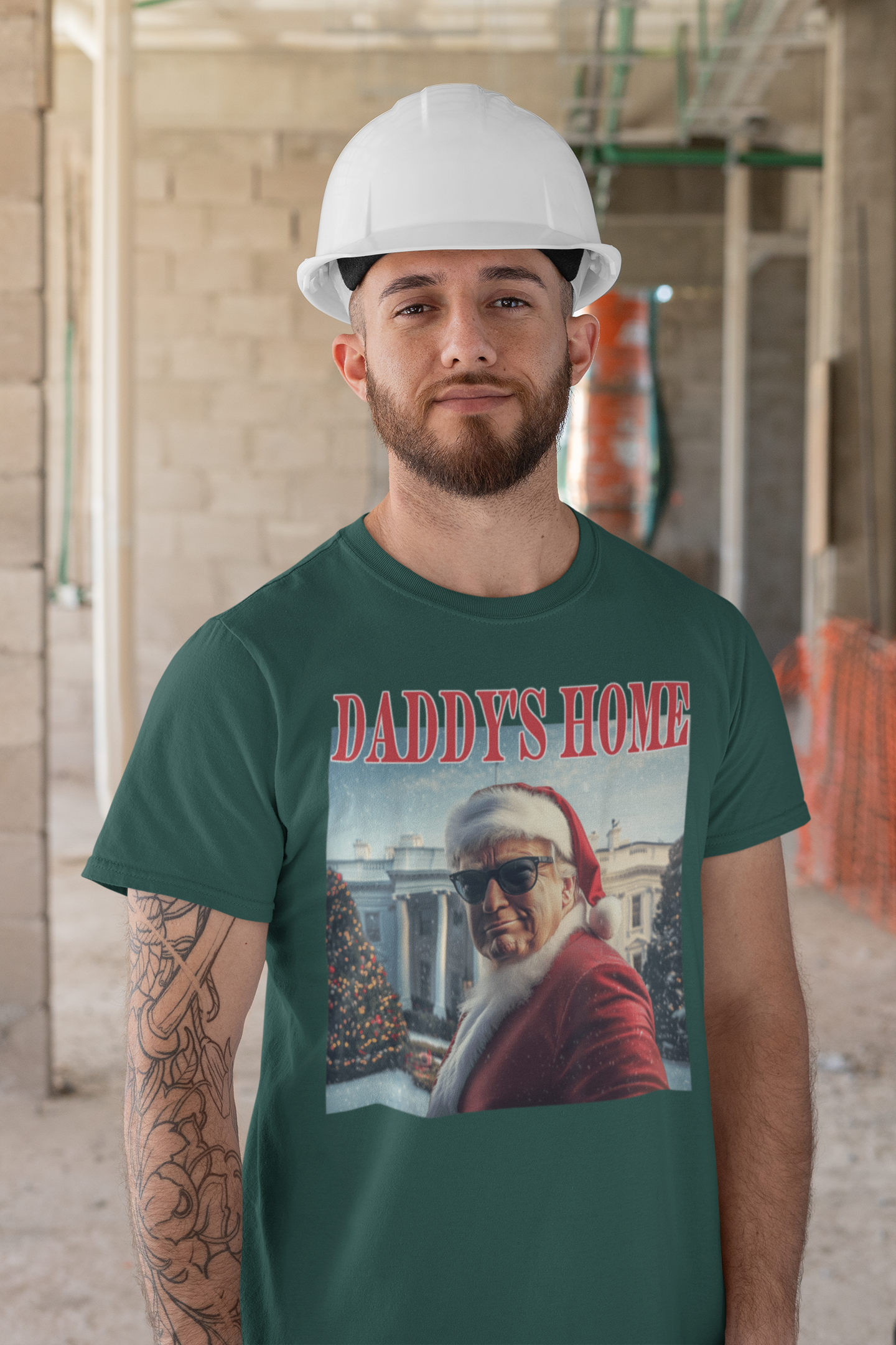 Man in green Daddy is Home Trump As Santa Tee with a hard hat in a construction site.