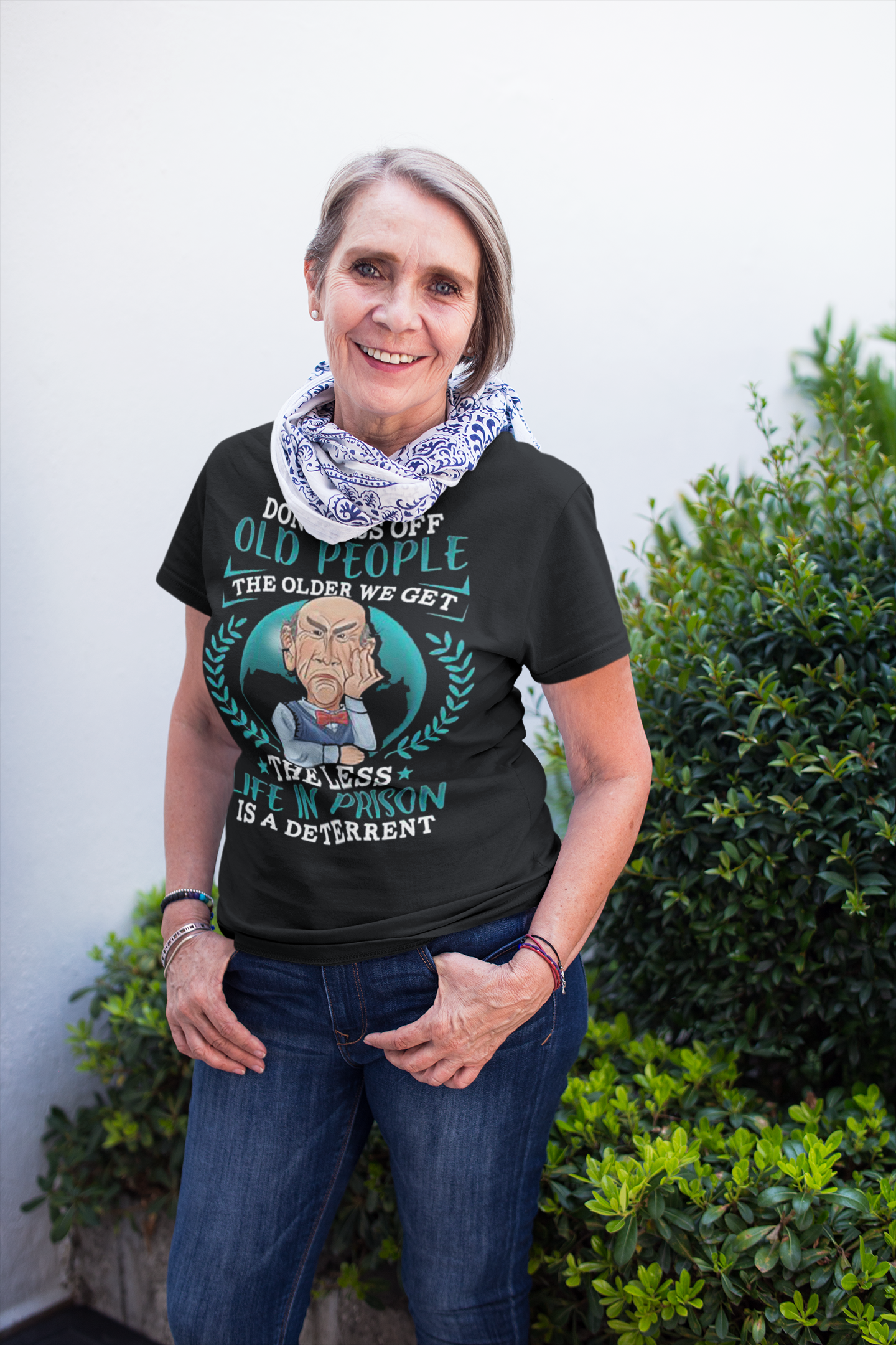 Smiling woman wearing a Don't Piss Off Old People Funny Tee outdoors.