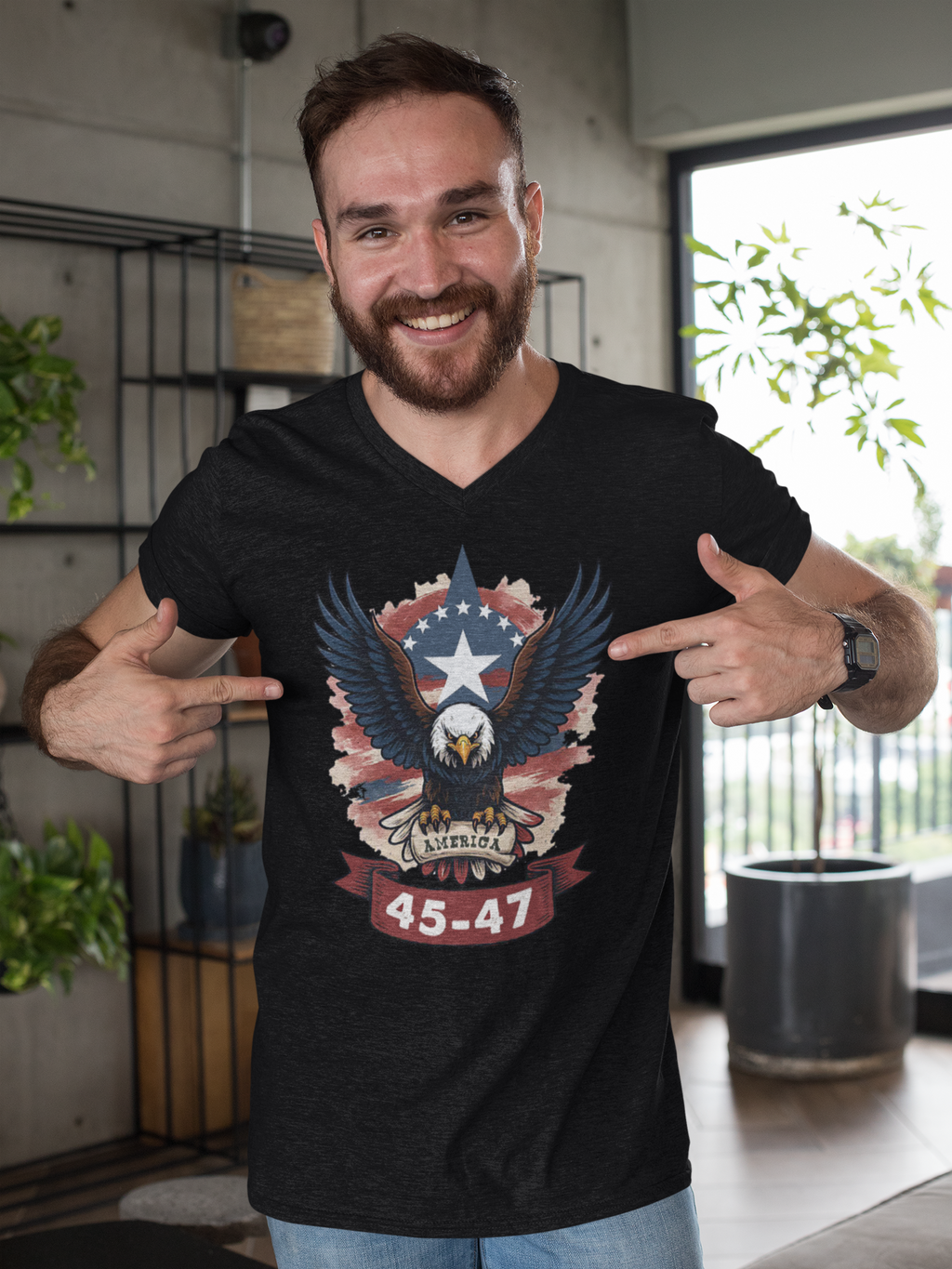 Smiling man in a black shirt featuring the Eagle America 45 47 Iconic Style graphic design, showcasing patriotism.