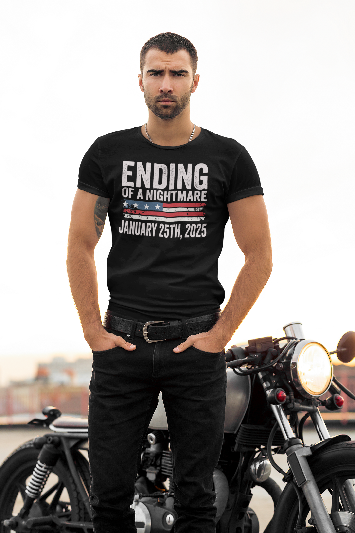 Man wearing black t-shirt with 'Ending Of A Nightmare On US Flag' design and motorcycle in background.