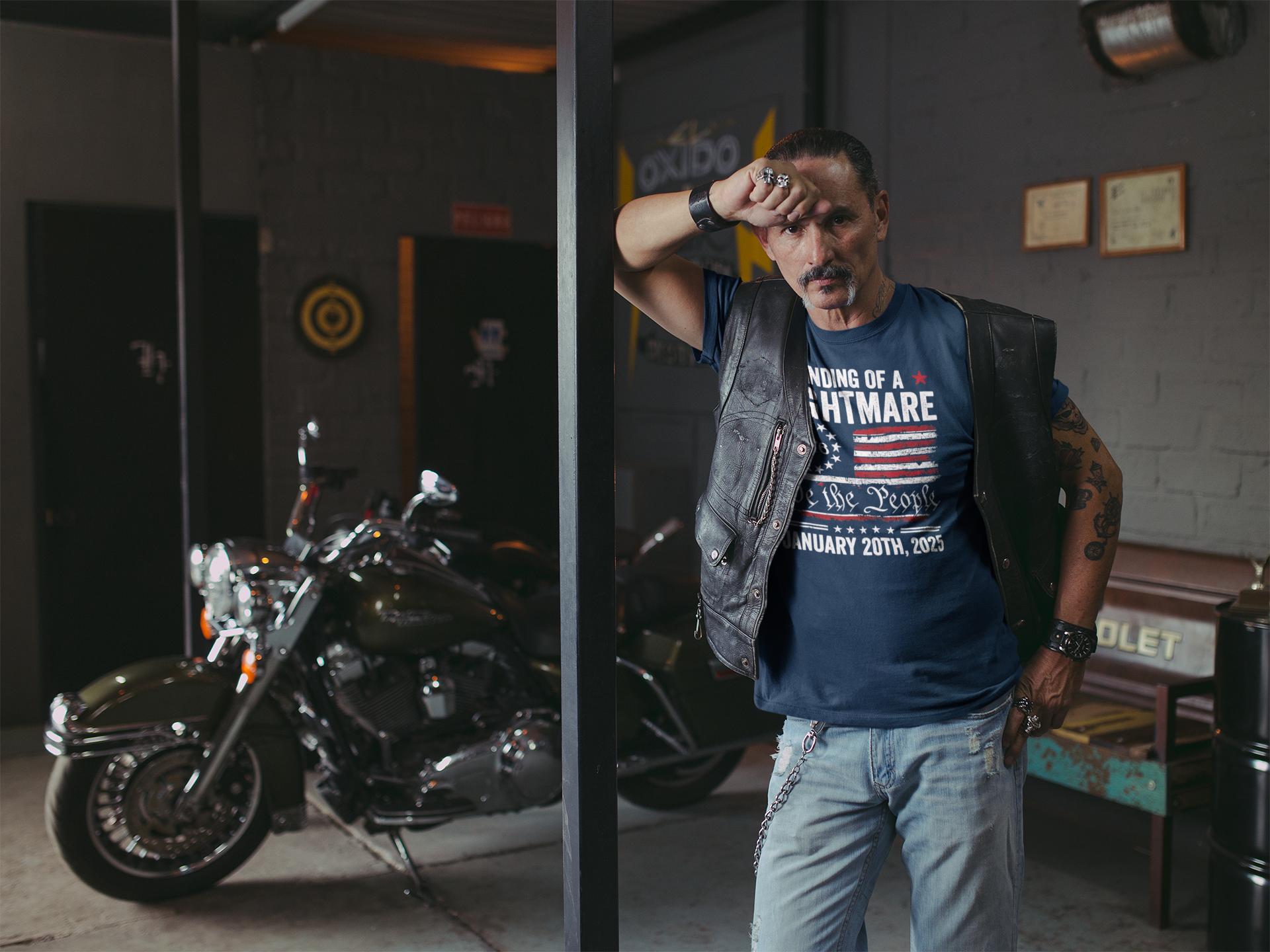 Man wearing Ending Of A Nightmare On 1776 Flag t-shirt in a motorcycle-themed room.