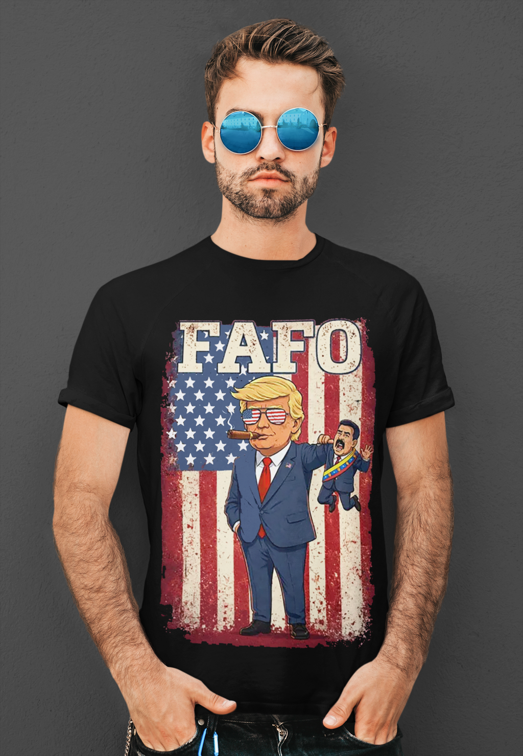 Man wearing a black t-shirt with a 'Trump Captures Maduro FAFO Now' graphic design and American flag background.