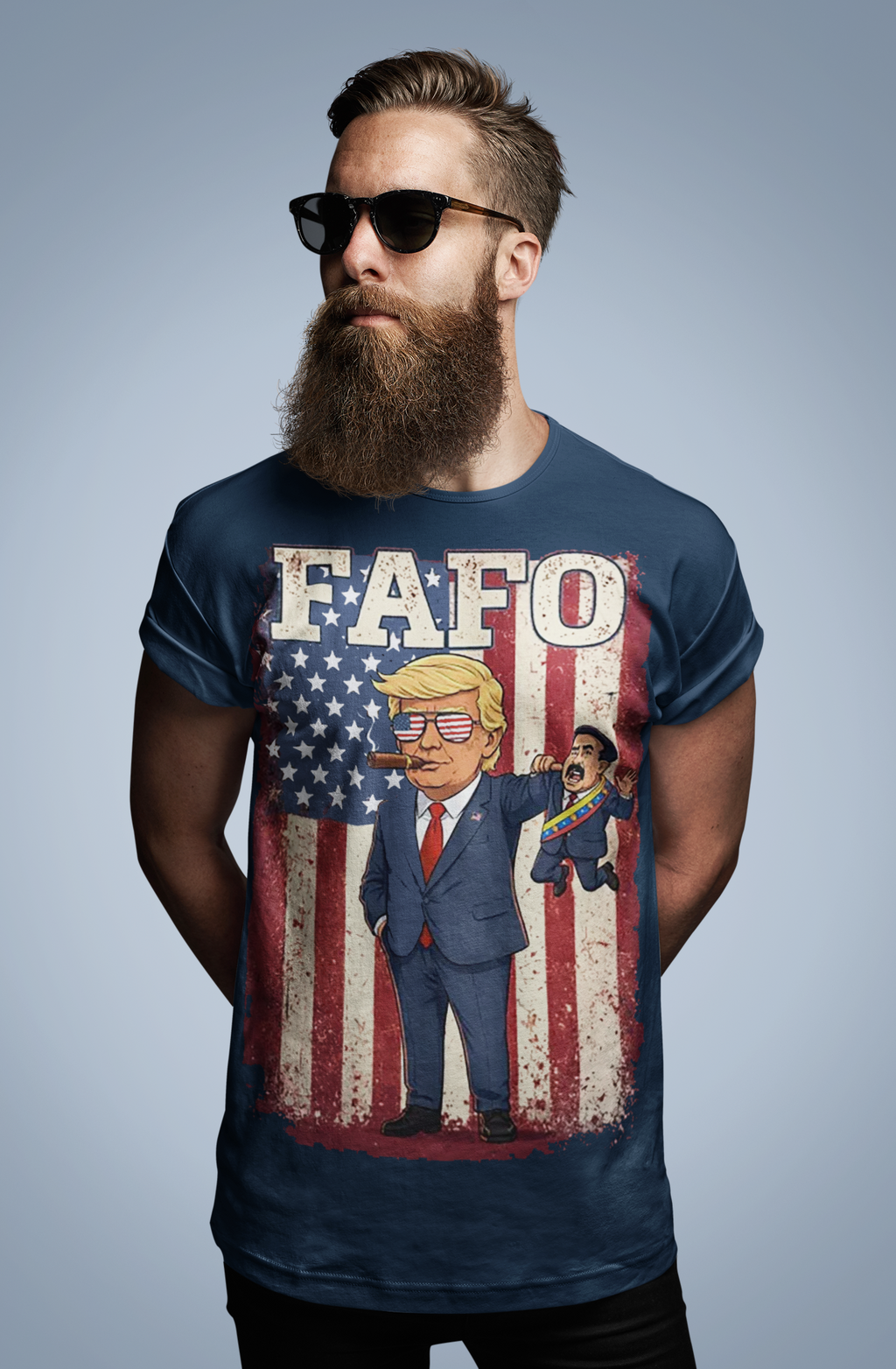 Trump Captures Maduro FAFO Now graphic tee featuring cartoon Trump against an American flag backdrop.