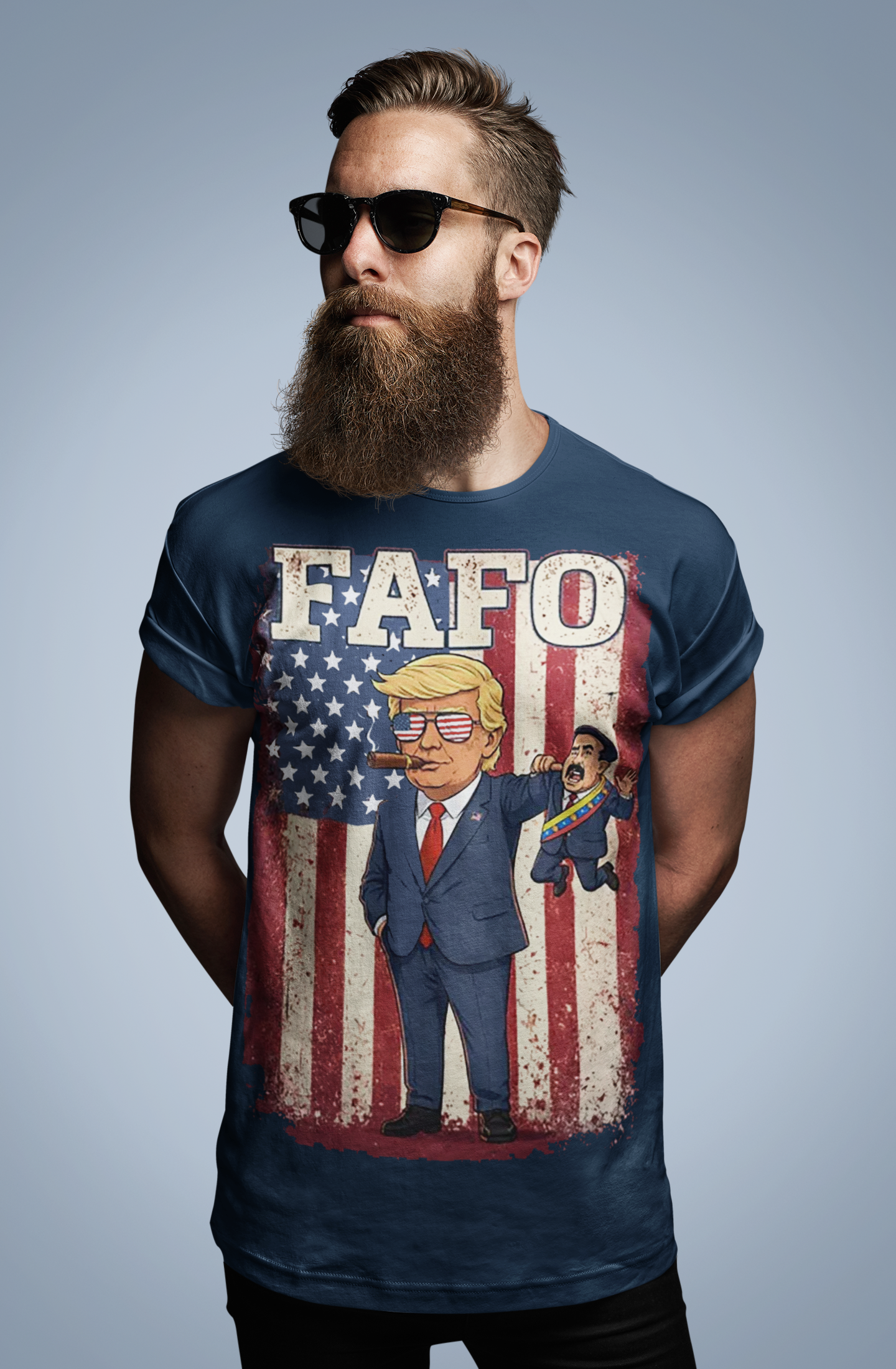 Trump Captures Maduro FAFO Now graphic tee featuring cartoon Trump against an American flag backdrop.