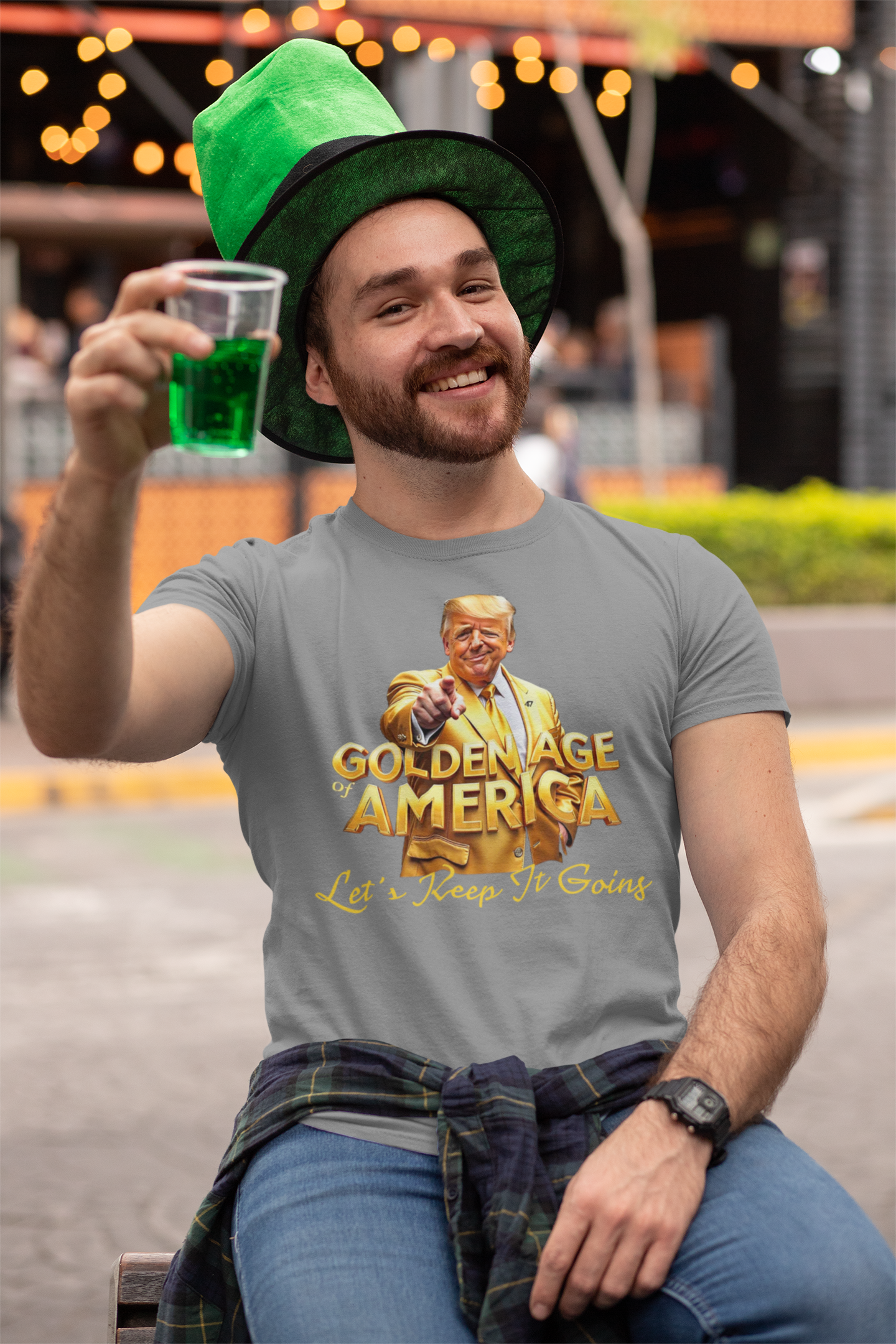 Man wearing Golden Age Of America Let's Keep It Going shirt, holding a drink, celebrating in festive attire.