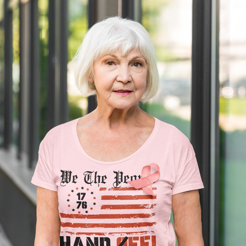 We The People 1776 Hands Off My Social Security shirt on a smiling older woman outside.