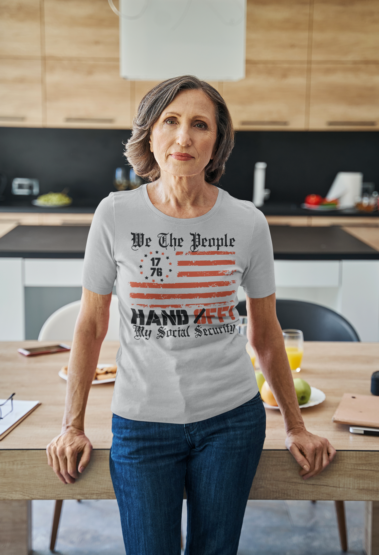 We The People 1776 Hands Off My Social Security shirt worn by a woman in a modern kitchen.