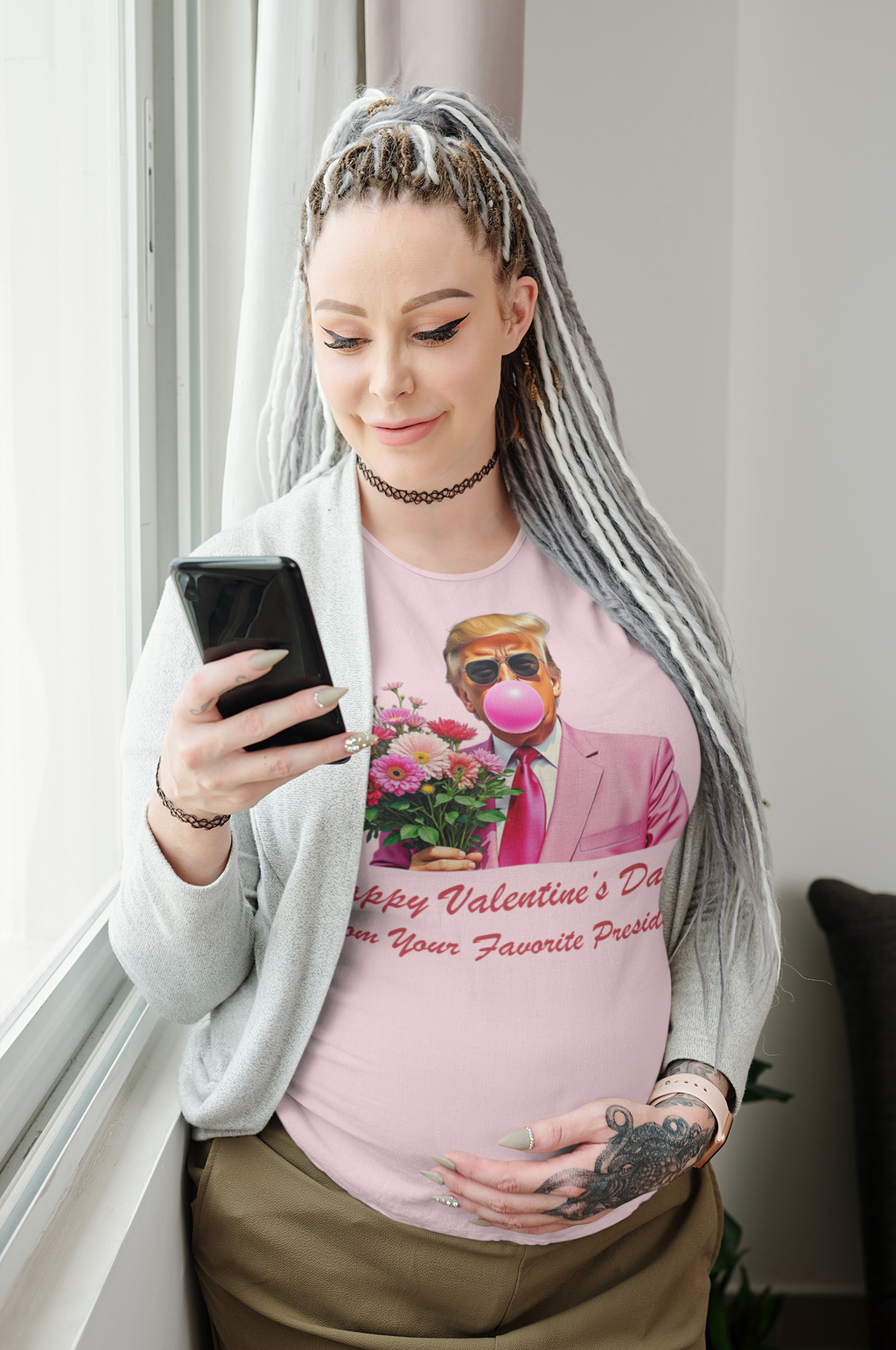 Woman wearing Happy Valentine's Day From Your Favorite President graphic t-shirt while holding a phone and smiling.