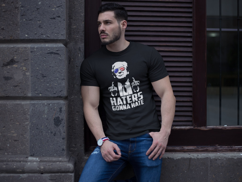 Man wearing a black t-shirt featuring the Haters Gonna Hate Graphic Design, highlighting a bold statement.