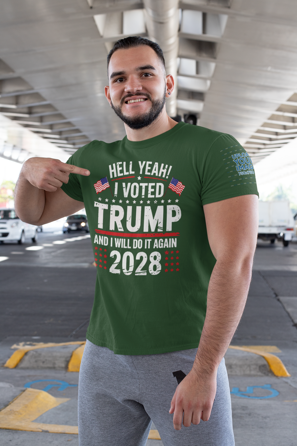 Hell Yeah I Voted Again 2028 Trump shirt worn by smiling man pointing to the design under a bridge.