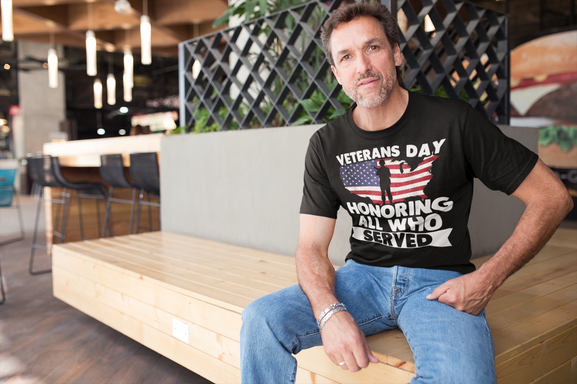 Man wearing Veterans Day Honoring Our Heros graphic t-shirt in a casual setting, supporting veterans.