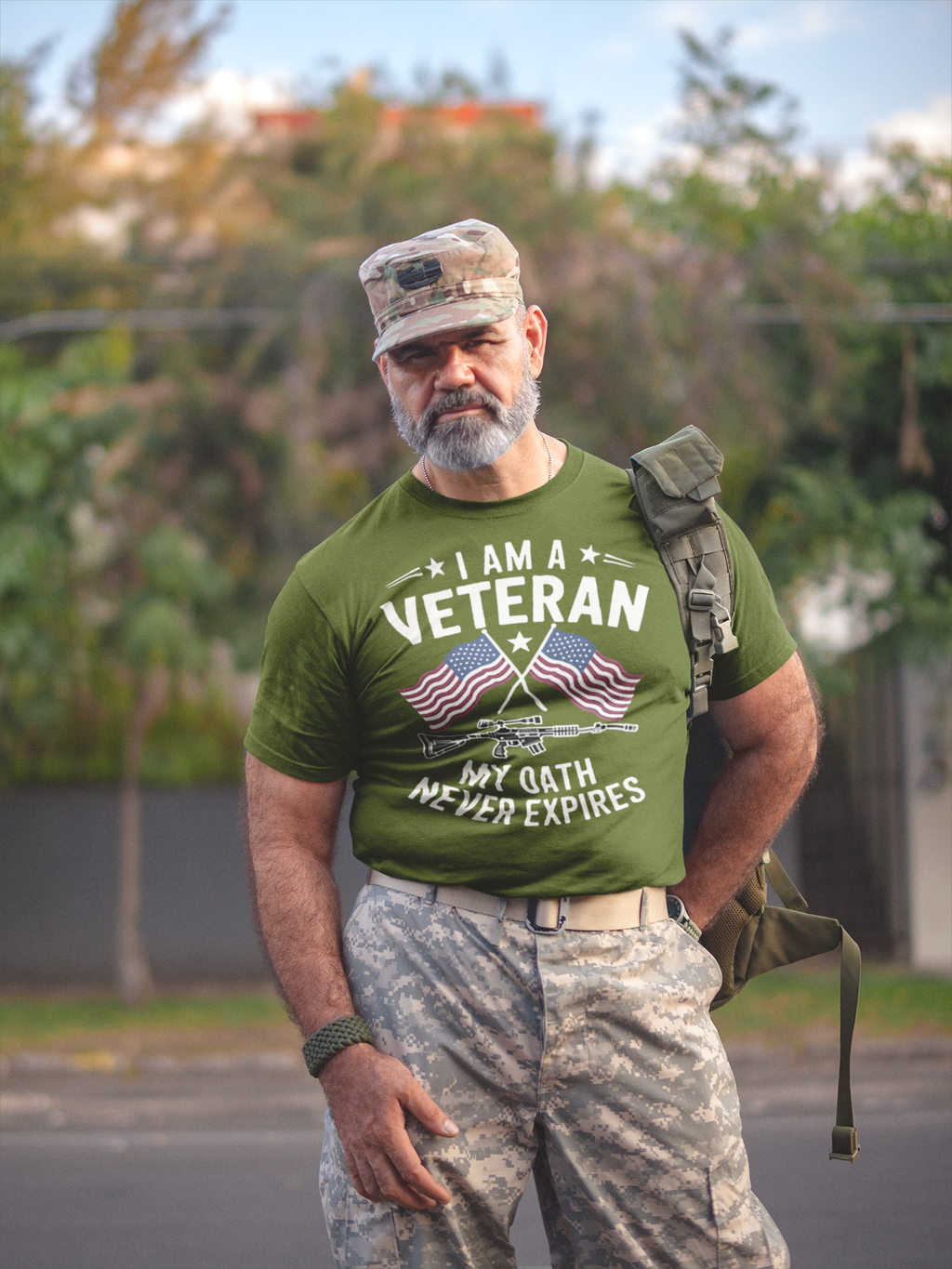 I Am A Veteran My Oath Never Expires t-shirt worn by a man in military attire outdoors.