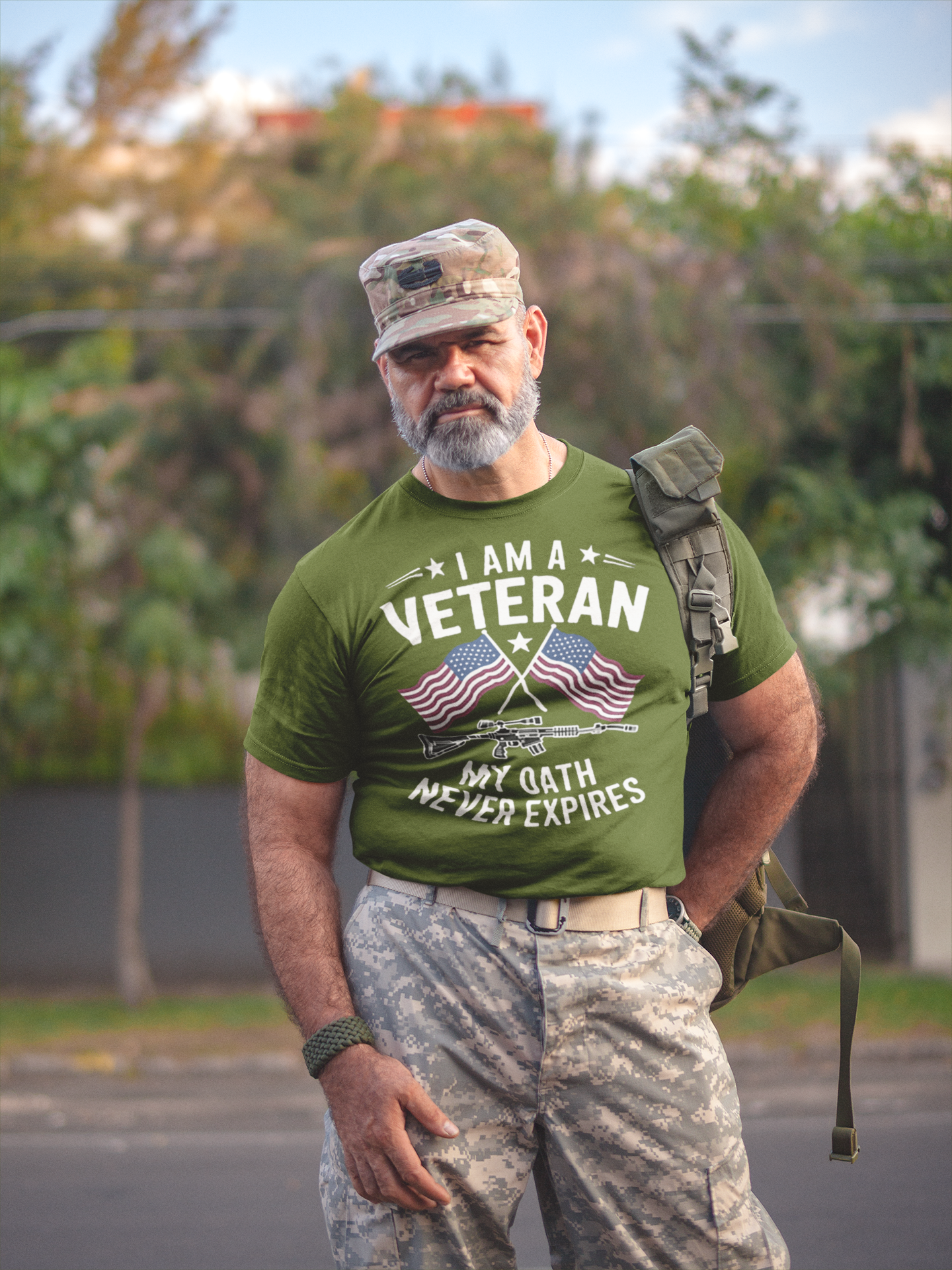 I Am A Veteran My Oath Never Expires t-shirt worn by a man in military attire outdoors.