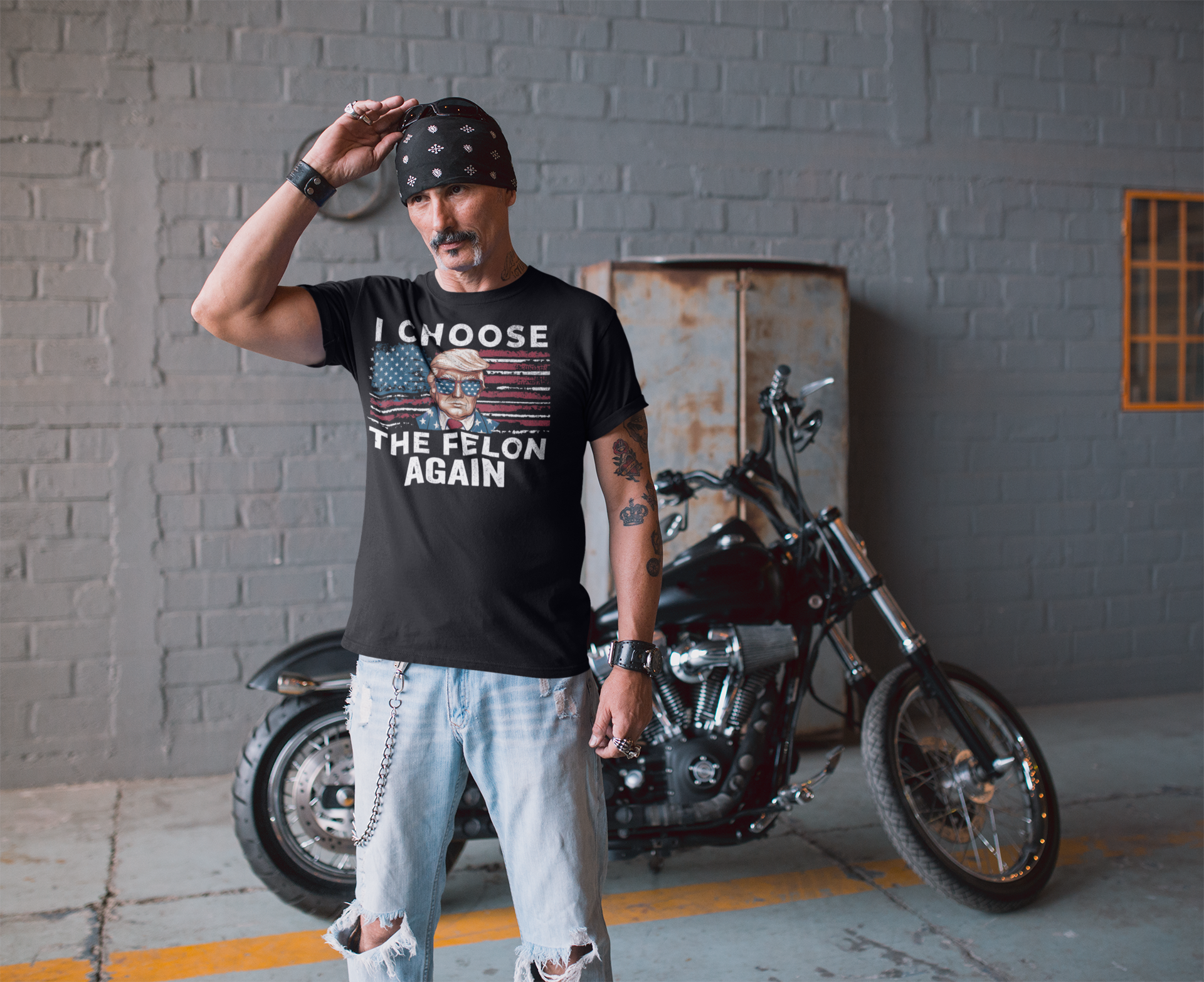 Man wearing a graphic tee that says I Choose The Felon Again Today, posing confident beside a motorcycle.