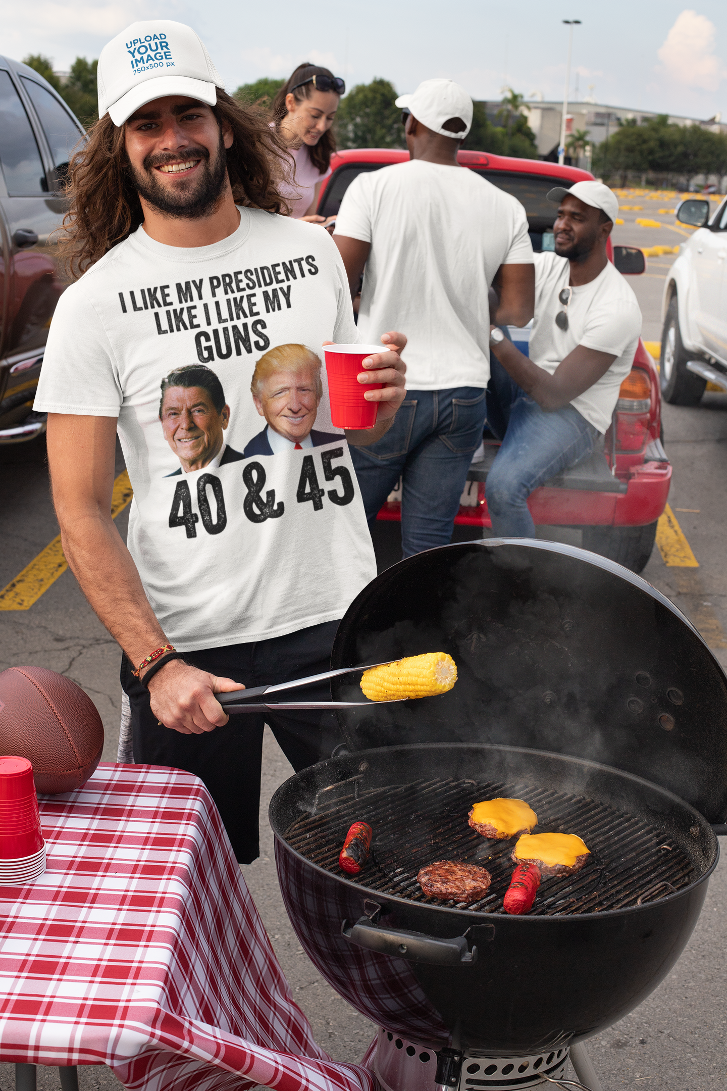 Man grilling at a barbecue wearing shirt that says I Like My Presidents Like I Like My Guns 40 & 45.